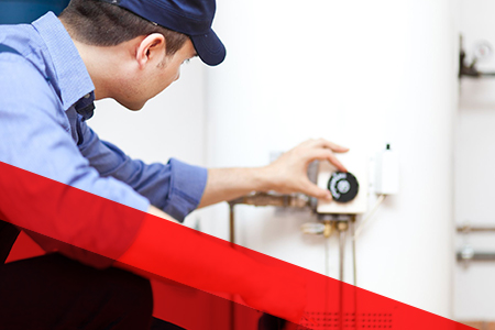 technician looking at water heater
